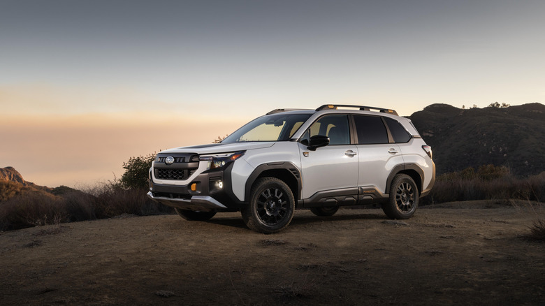 The 2025 Subaru Forester Wilderness in white with black wheels, front 3/4 view