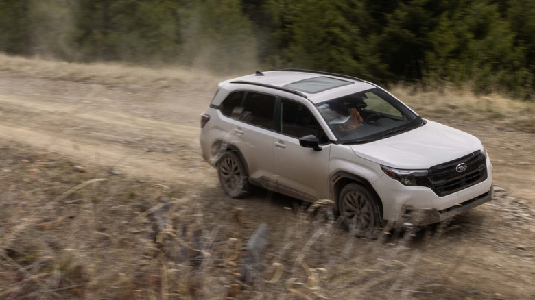 Overhead view of white Subaru Forester on off-road trail.