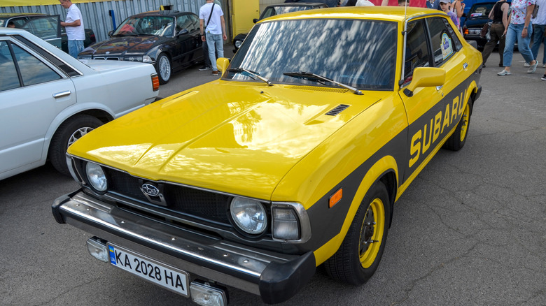 Yellow Subaru Leone with black racing stripes