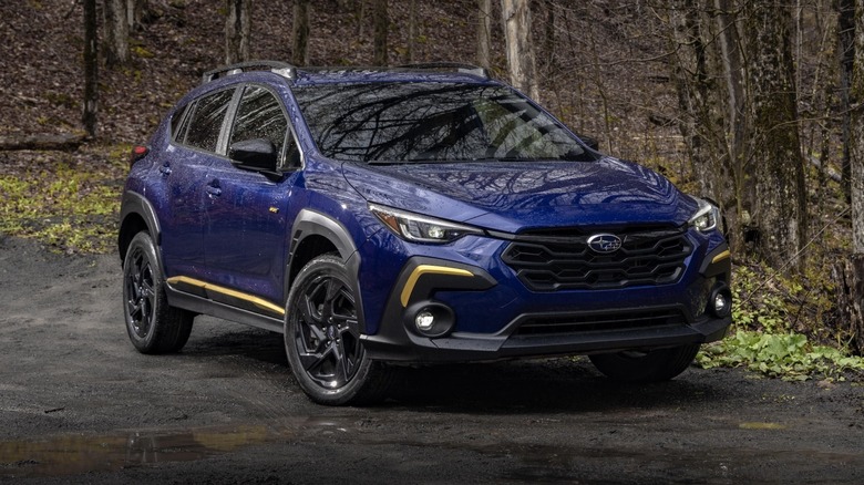 Subaru Crosstrek Sport parked on a dirt road in a forest