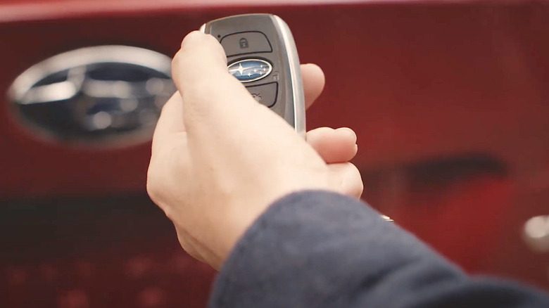 Person using key fob to set up Pin Access panel on their Subaru