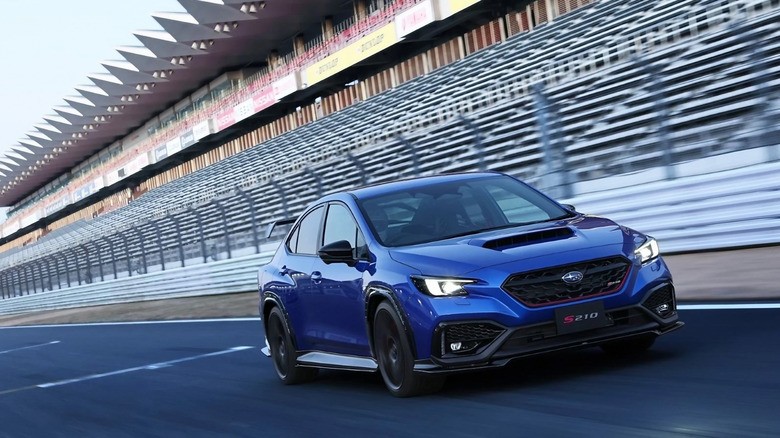 the STI-branded WRX S210 races down a track