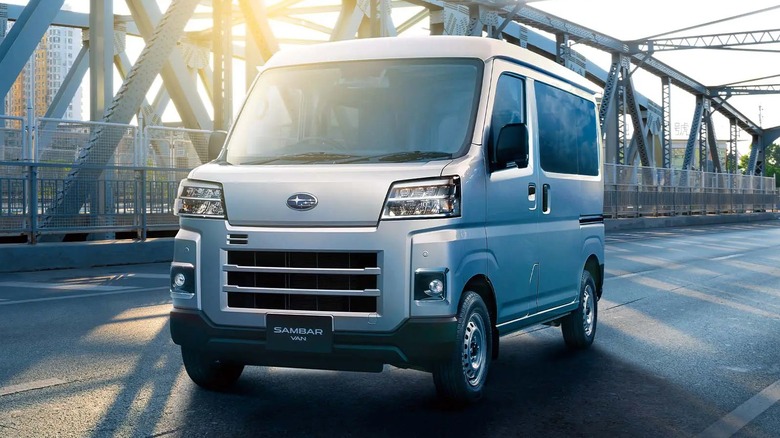 Silver Subaru Sambar van parked on a bridge in the morning