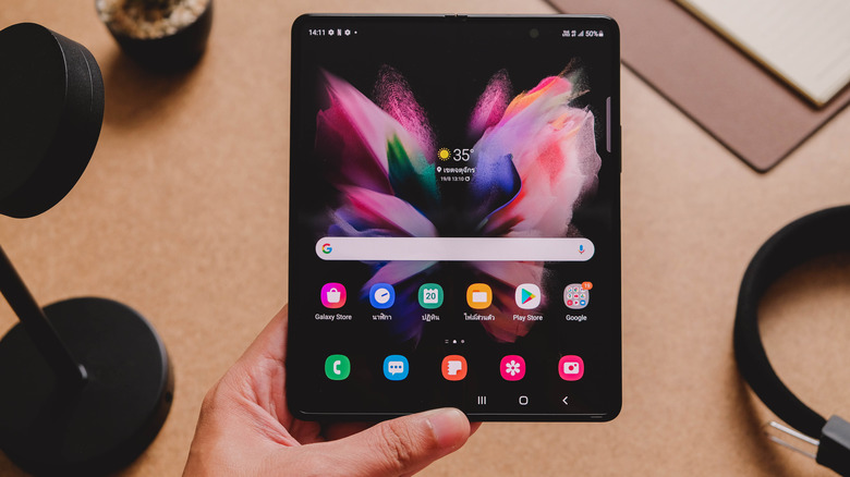 Holding the Samsung Z Fold 3