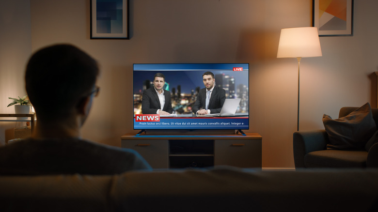 Man watching news on TV