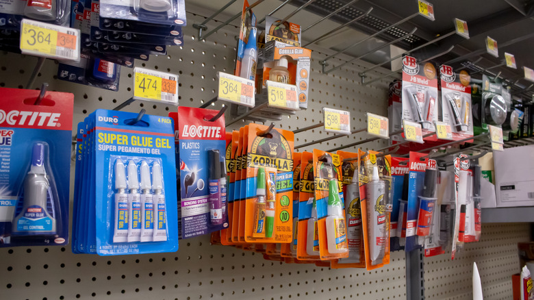 A view of several packages of super glue, on display at a local retail store.