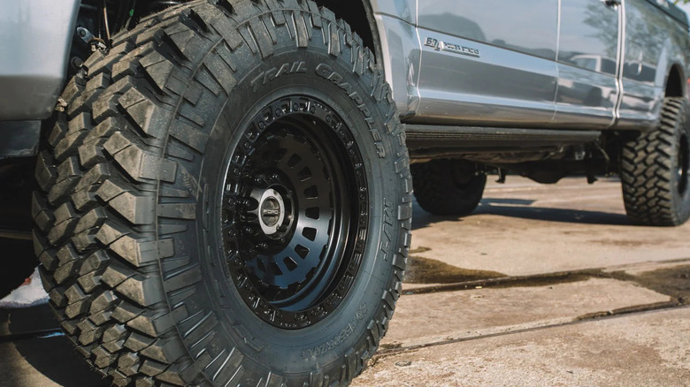 A close up of a pickup truck with two super single tires at the front and the rear
