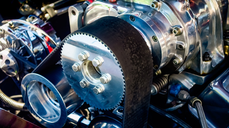 The belts and pulleys on a supercharger
