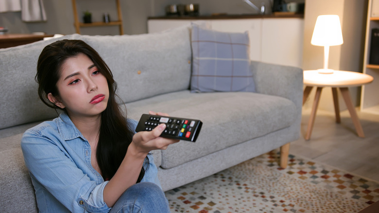 A person frustrated with their slow smart TV