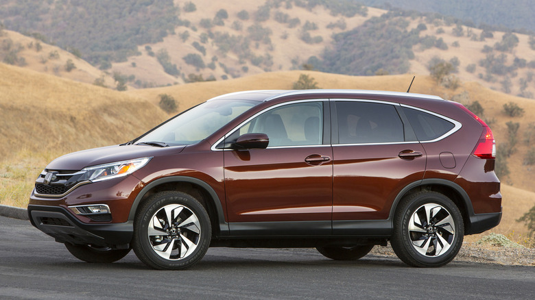 A dark red 2015 Honda CR-V parked in a remote location
