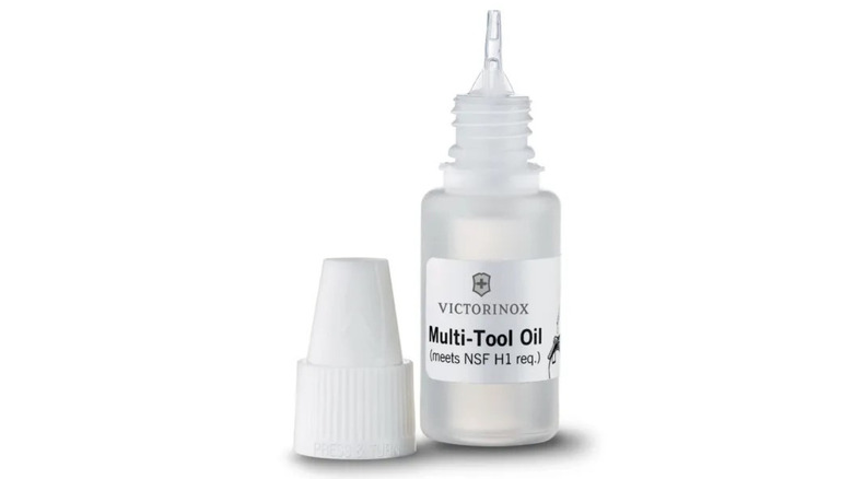 A bottle of Victorinox Multi Tool Oil with its cap off and a white background