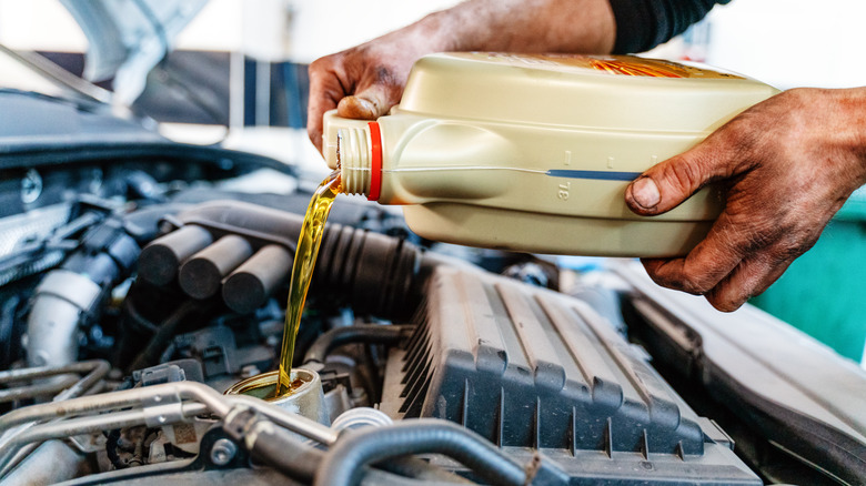 Man pours out engine oil