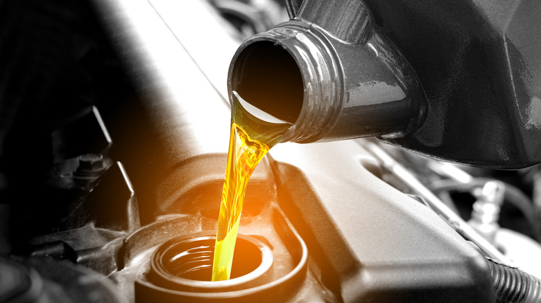 Close-up of motor oil being poured into an engine