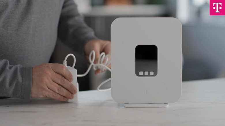 Person plugging in T-Mobile 5G gateway to power