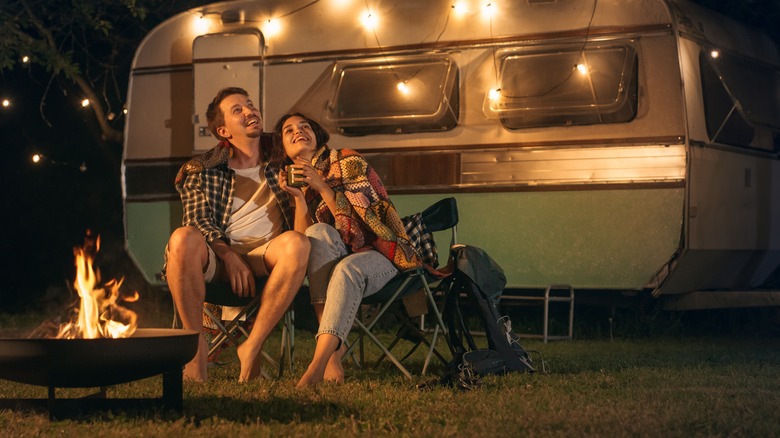 Couple camping outside RV