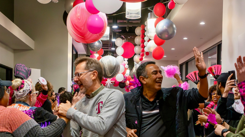T-Mobile's present and future CEO,  Mike Sievert (left) and Srini Gopalan (right) celebrate with employees.