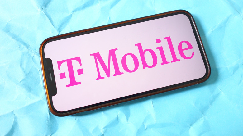 A picture of a smartphone with the pink T-Mobile logo, against a blue background