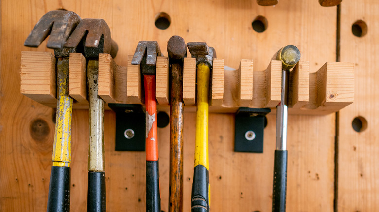 workshop rack with multiple hammers