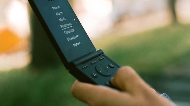 Close up of a user holding a Light Flip and navigating its main menu