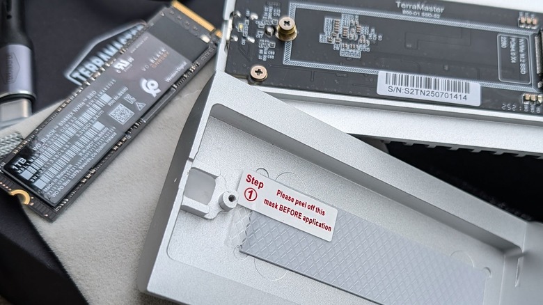 TerraMaster SSD enclosure with SSD nearby and thermal paste.