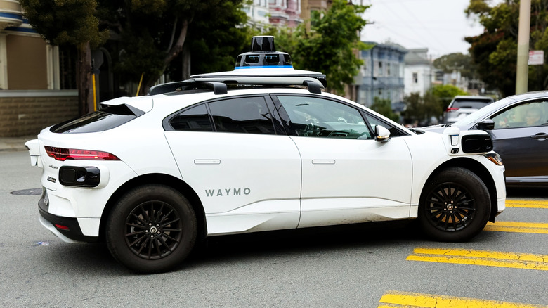 A Waymo vehicle turns a corner.