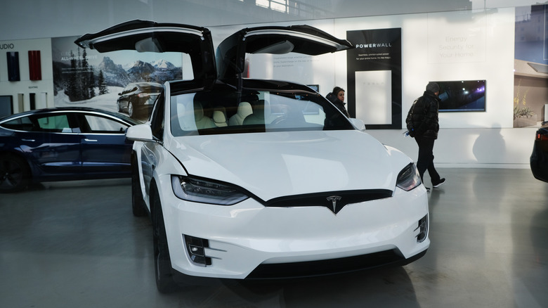 A Tesla car with doors open.