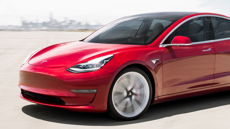 Red Tesla Model 3 outdoors