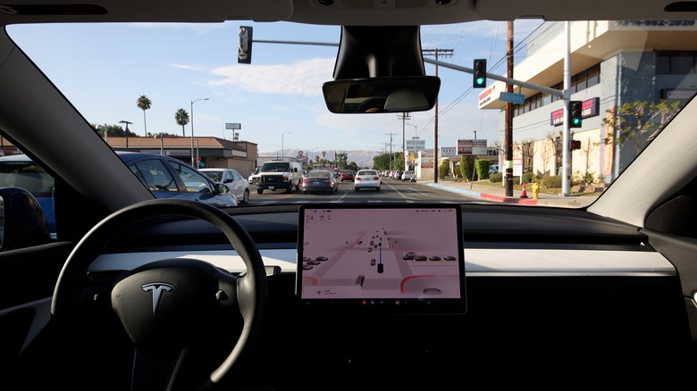 A Tesla Model Y in self-driving mode on an LA street