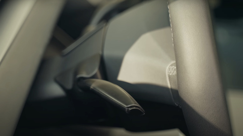 A side shot of the S3EXY Stalk by Enhance Auto connected to the Tesla steering wheel.