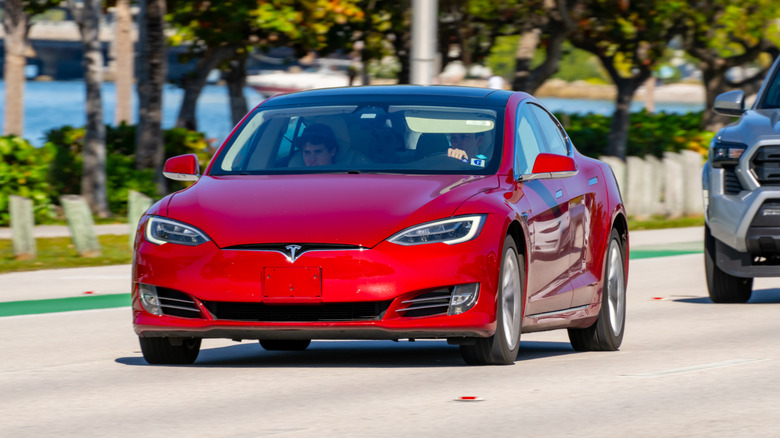 Red Tesla Model S on the road