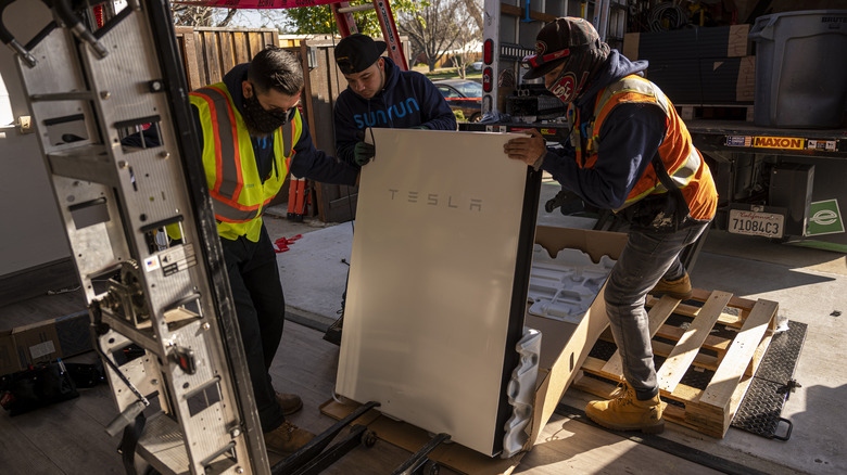 Installers installing a Tesla Powerwall