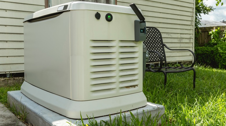 Home standby generator in backyard