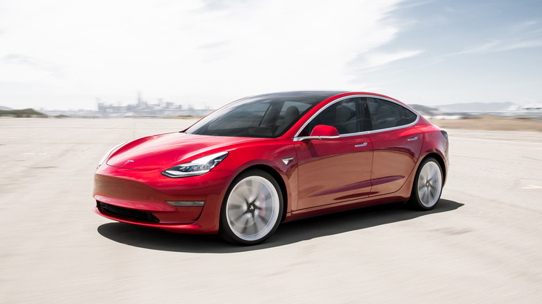 A Tesla Model 3 driving fast