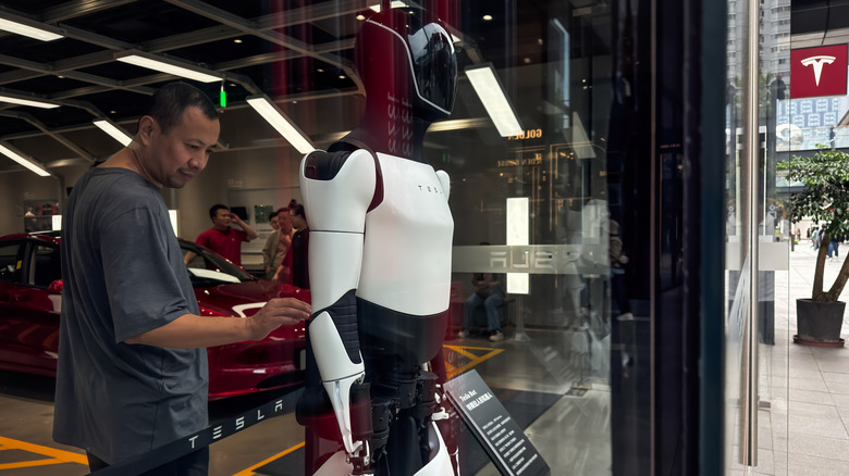 Human behind an Optimus robot.