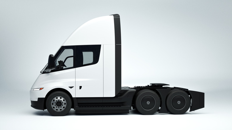 Side view of white Tesla Semi parked in studio.