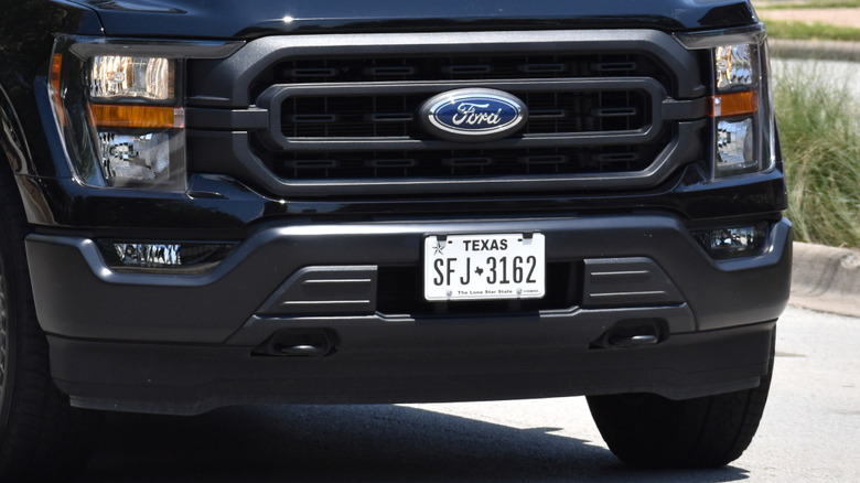 front of black Ford truck with Texas license plate