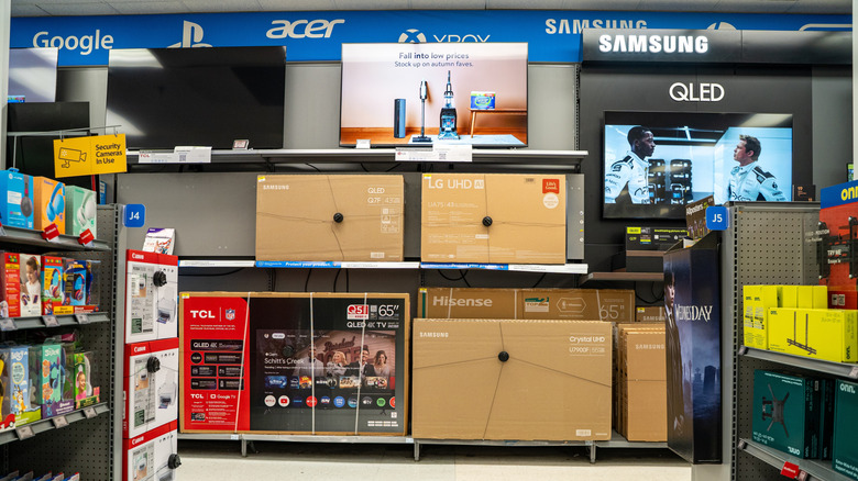 Smart TVs on display in Walmart store aisle