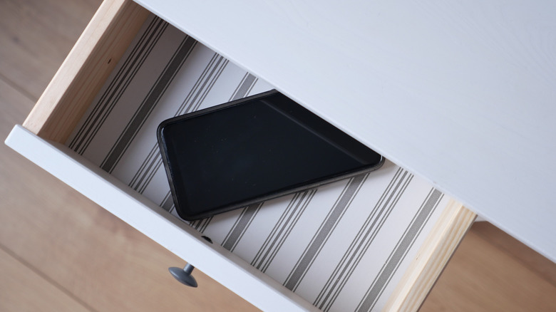 Smartphone in an open drawer