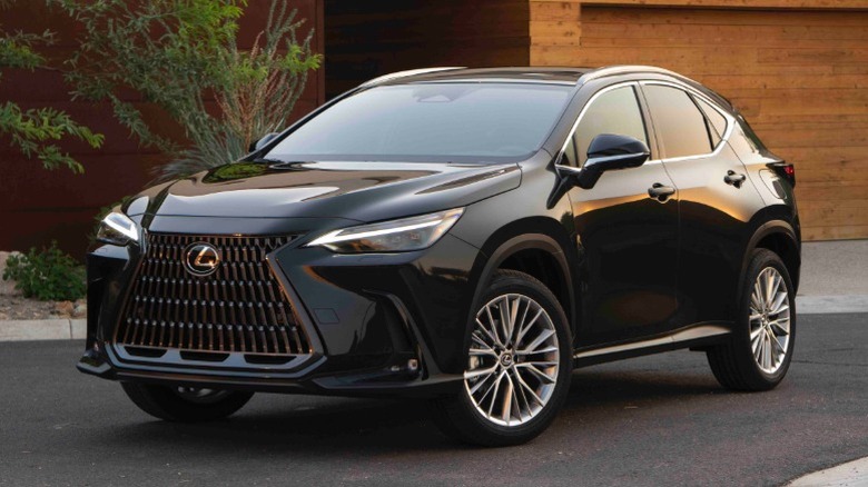 Black Lexus NX 350 parked in front of a building