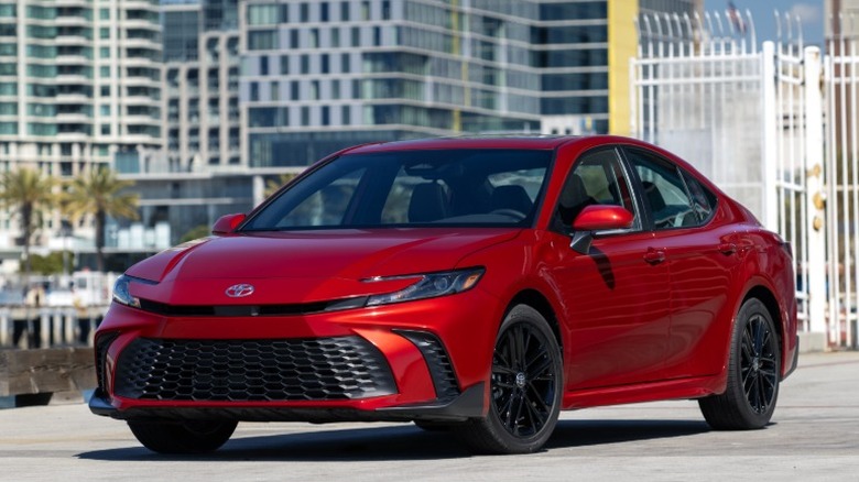 Red Toyota Camry parked in an urban environment