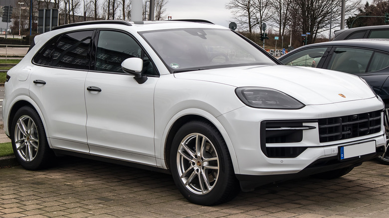 A white Porsche Cayenne in a parking space