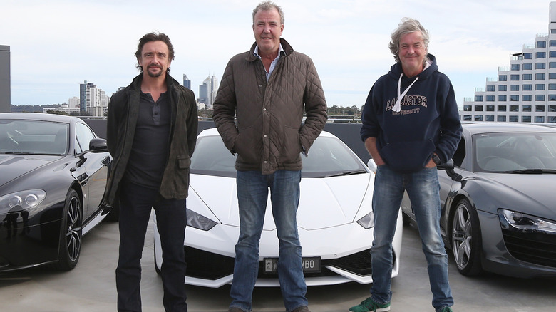 Top Gear hosts posing by car