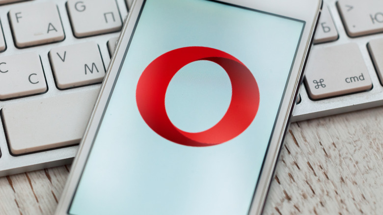 Opera em um iPhone, deitado em um teclado Apple