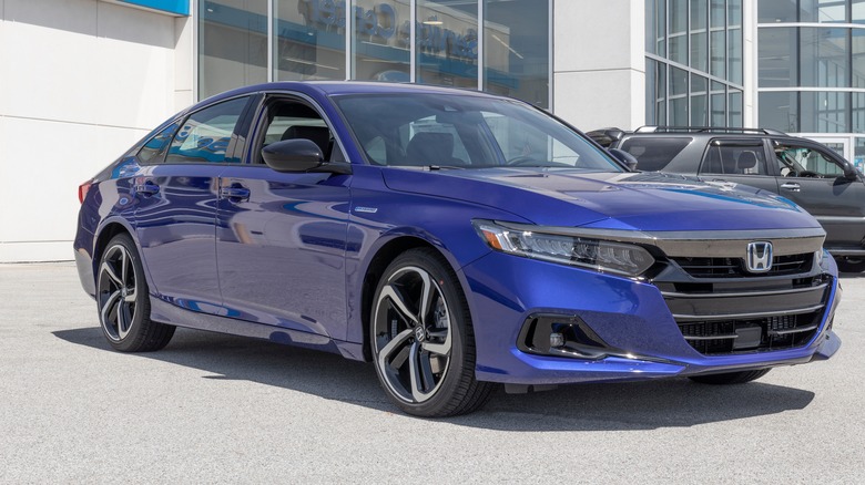 Blue Honda Accord hybrid parked outside a dealership