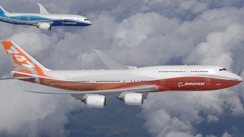 Boeing 747-8 in the clouds with 787 tailing behind