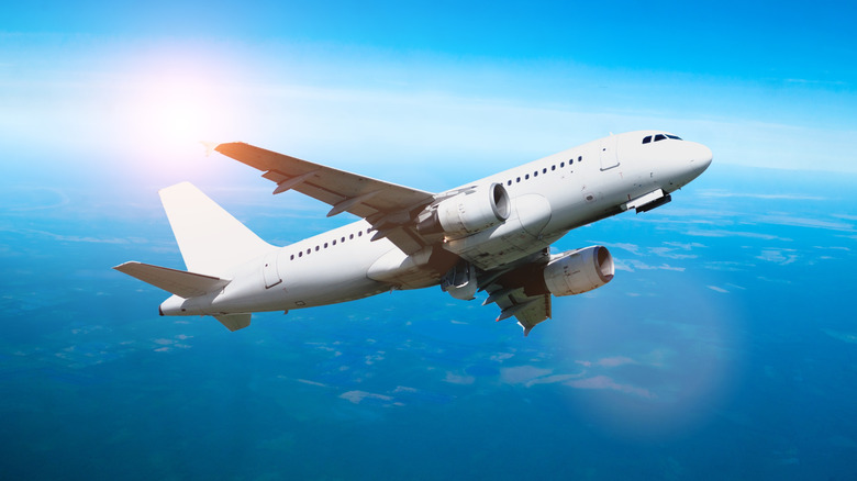 Passenger jet soaring through the blue sky