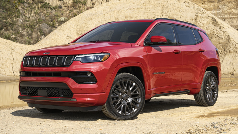 Red Jeep Compass parked in what looks like a desert area