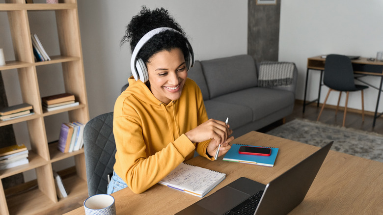 woman on laptop with wireless headphones