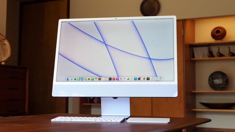 Blue Apple iMac sitting on a wooden desk