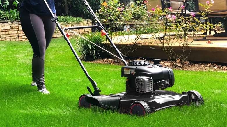Landscaper mowing lawn with Hyper Tough mower